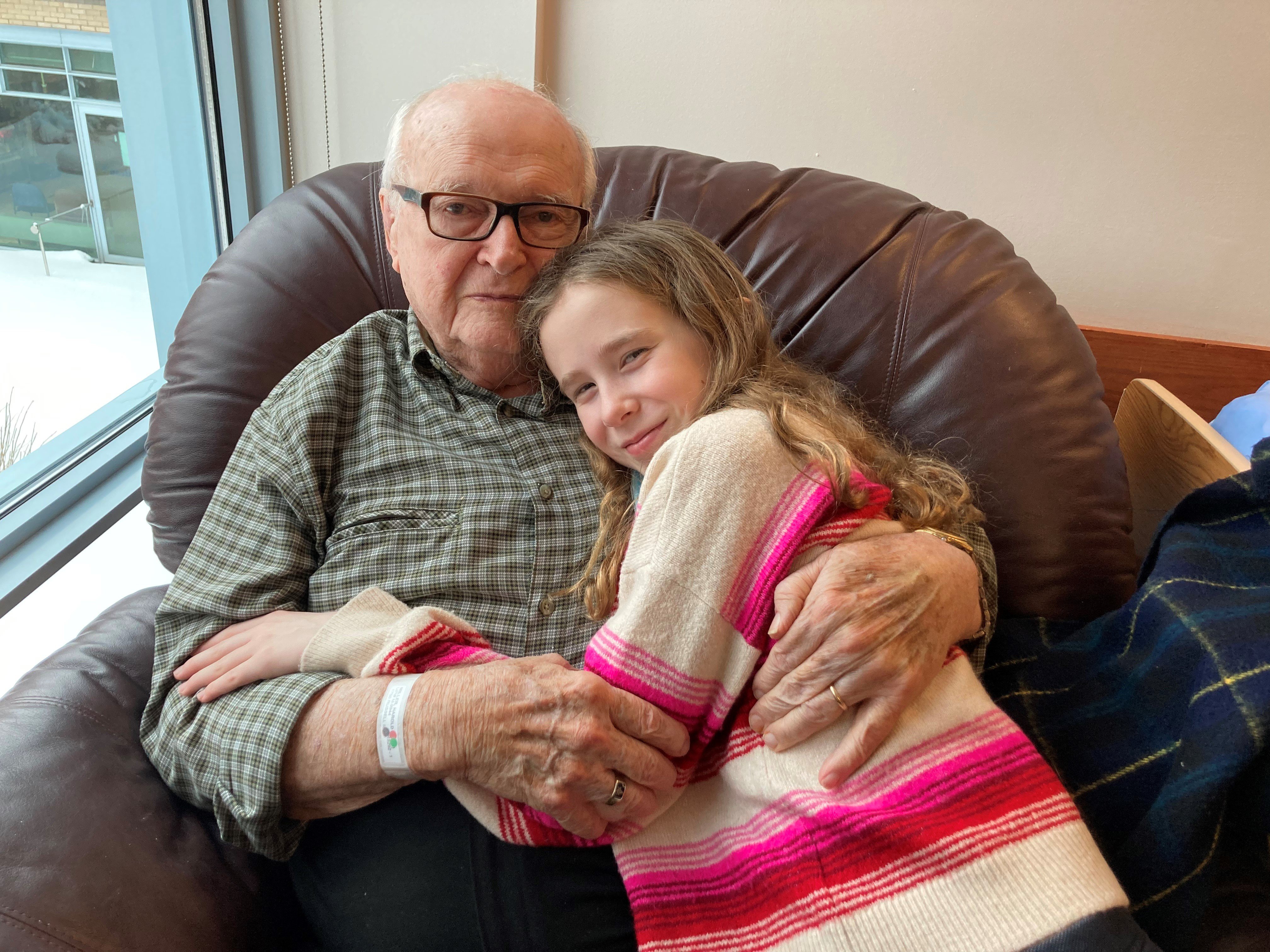 Victoria lovingly hugs her "Grampie" Harold Miller, RCAF Veteran and Perley Health resident. Victoria and her Grampie